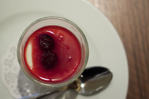 Milk pudding with sour cherry syrup